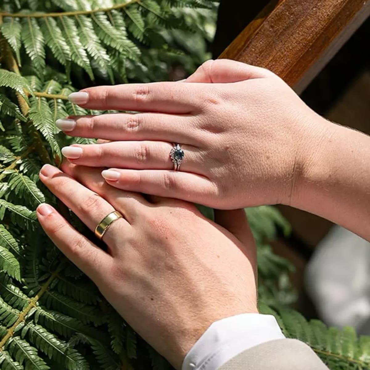 Sapphire engagement and wedding rings among fern leaves